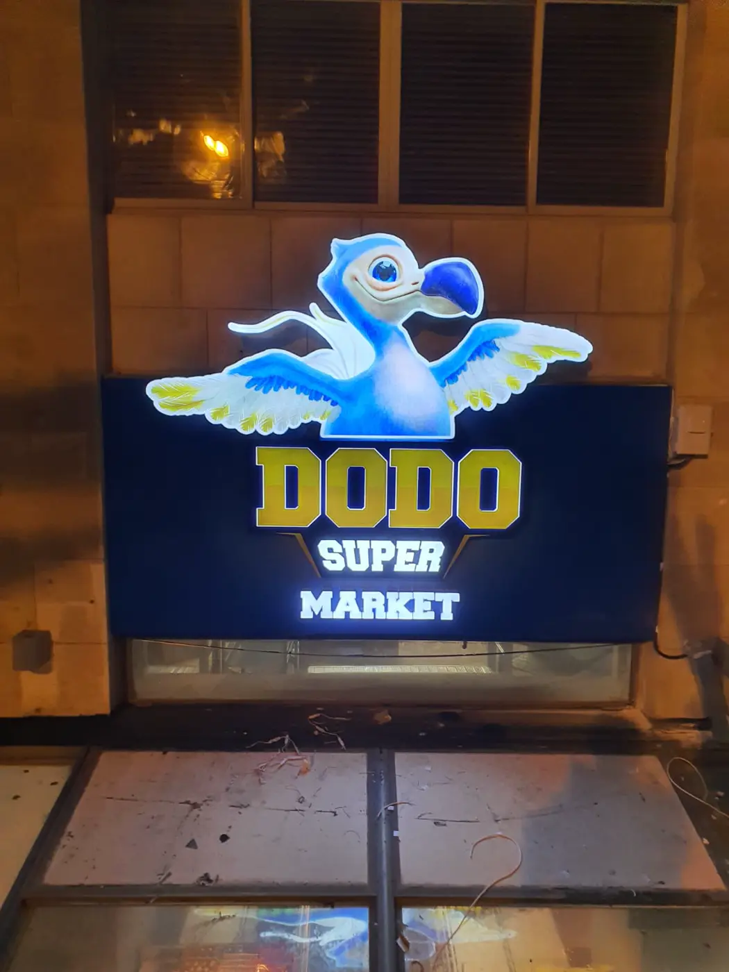 ארגז מואר בצורת דמות ציפור מעל סופרמרקט
